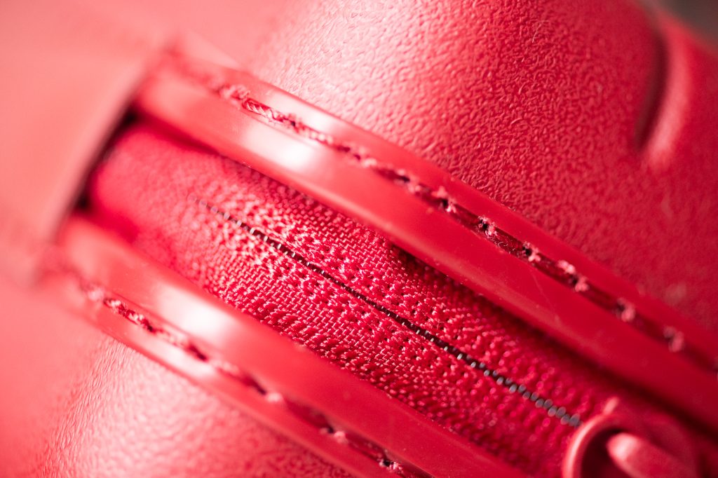 Away bag zipper details in Tango Red